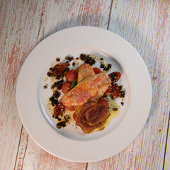 Fish recipe, Fillet of red mullet, crushed cherry tomatoes and olives. High quality photo
