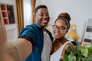A couple in love moves into their first apartment, take a picture together with their phone on social media after moving in, smiling, happy, bragging about their new home