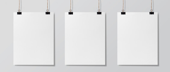 Three blank white poster hanging up, Mock-up poster and mockup template isolated on  white...