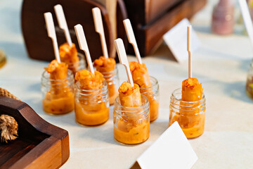Catering. convenient portioned serving of salads with sauce in small jars. beautiful original table setting for banquet.