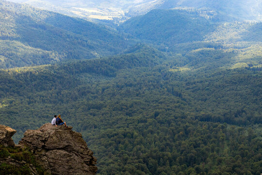 Couple Enjoying Mountain View on Rock Peak. Amazing Mountain Scenery