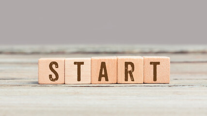 Start word written on cubes in table top concept image 