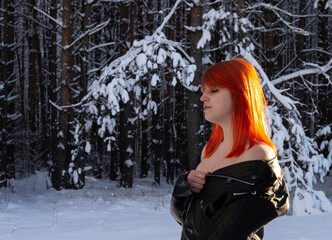 beautiful girl with red hair on the background of nature