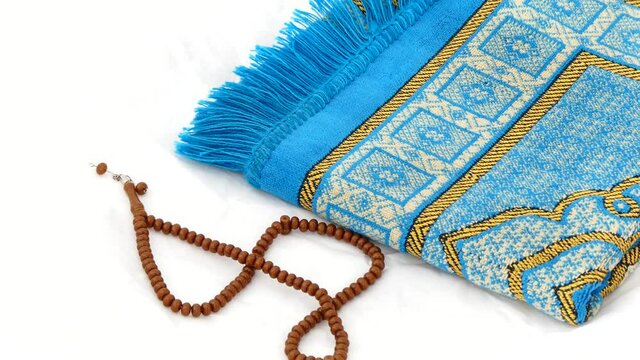 close-up prayer rug and rosary, Islam and prayer rug, on the prostration Muslims pray on,