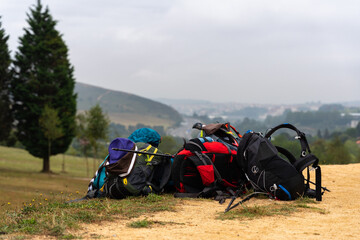 Hiker's backpacks piled up on the hill
