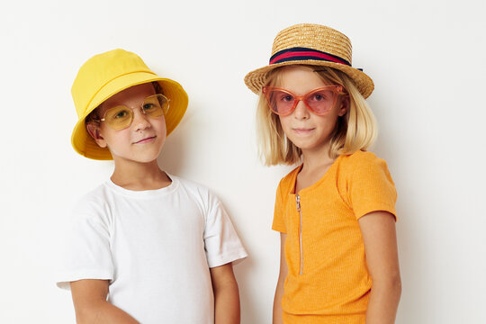 boy and girl wearing hats fashion glasses posing friendship fun