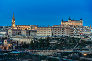 Naklejka na ściany i meble Panoramic view of the city of Toledo in Spain, with the cathedral and the alcazar - blue hour.