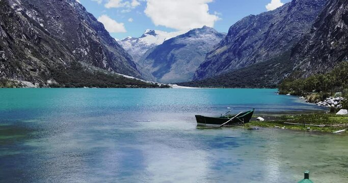 Llanganuco lake, boat and snow capped mountain huascaran, Ancash, Peru - UHD