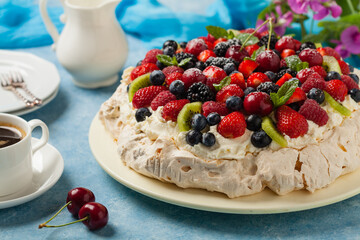 Meringue Pavlova cake with fresh fruit. Front view.
