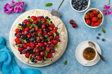 Meringue Pavlova cake with fresh fruit. Top view.