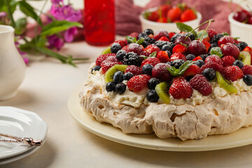 Meringue Pavlova cake with fresh fruit. Front view.