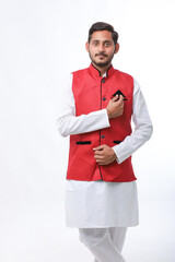 Young indian farmer in traditional wear and giving expression on white background.