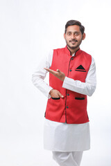 Young indian farmer in traditional wear and giving expression on white background.
