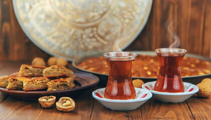 Baklava on the table and tea in Turkish glasses. Selective focus.