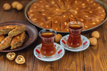 Baklava on the table and tea in Turkish glasses. Selective focus.