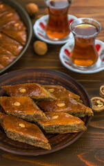 Baklava on the table and tea in Turkish glasses. Selective focus.