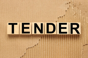 TENDERS text on five wooden blocks. cubes on torn paper