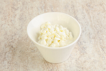 Grained cottage cheese in the bowl