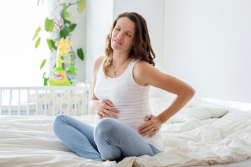 Young beautiful pregnant woman, in pain with labor contraction