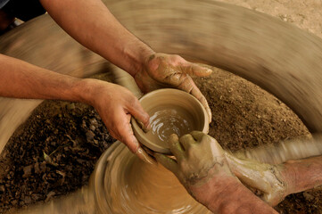 An Indian Artisan hands making clay pots 