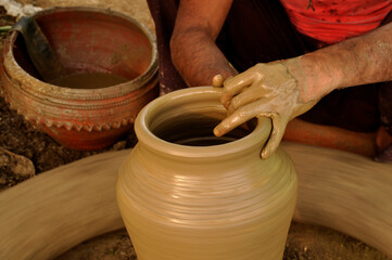 An Indian Artisan hands making clay pots 