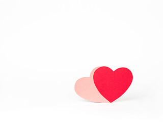 two paper hearts on a white background