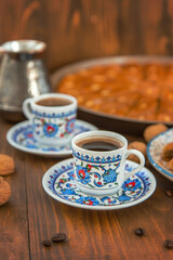Baklava on the table and Turkish coffee. Selective focus.