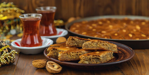 Baklava on the table and tea in Turkish glasses. Selective focus.