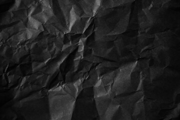Textured crumpled black paper background.