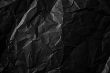 Textured crumpled black paper background.