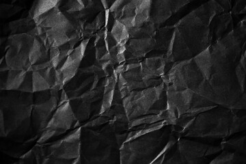 Textured crumpled black paper background.
