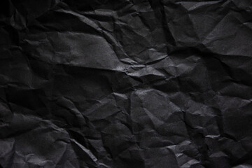 Fototapeta premium Textured crumpled black paper background.