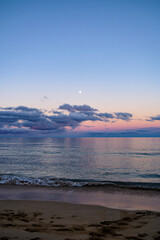 Moon rising above the ocean in cape verde