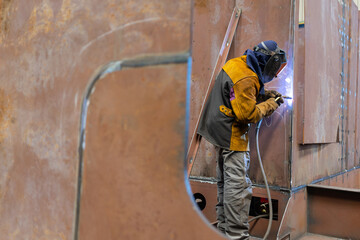 Detailed photo of a welder in a shipyard