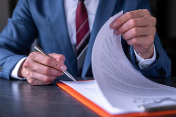 business man reading and signing a business contract, business agreement consensus signing,...