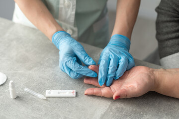 Obraz na płótnie Canvas Close up female doctor's hands in white coat and medical gloves holding test tube for testing in hematology laboratory at hospital, medical and science concept