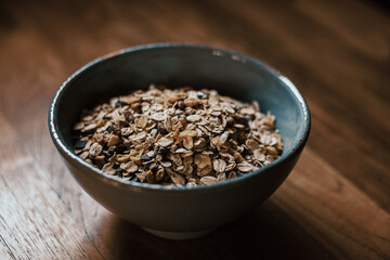 cereal flakes in blue bowl on wooden table