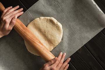Baking sweet cottage cheese braided bread with raisins and jam. Rolling out the dough in the...
