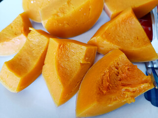 Close up butternut squash slice on white plate background.