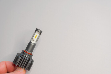 Modern LED headlight bulb for cars on a light gray background