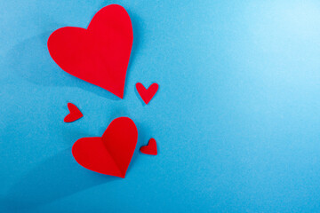 red hearts on blue paper