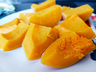 Close up butternut squash slice on white plate background.