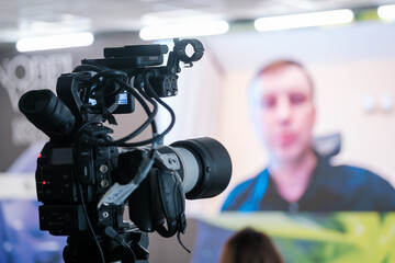 Professional camera shooting video of online conference