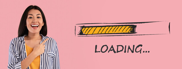 Smiling young Asian woman pointing at loading progress bar over pink studio background, creative collage