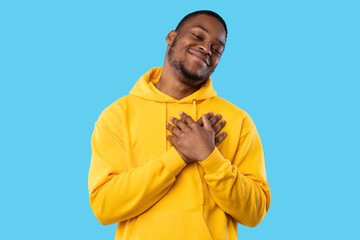 Thankful African Guy Pressing Hands To Chest Over Blue Background