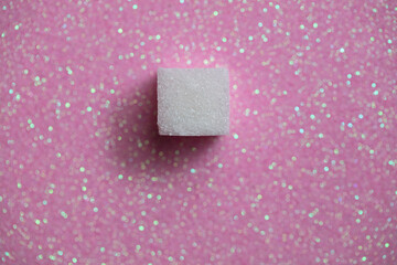 Sugar cubes on pink background