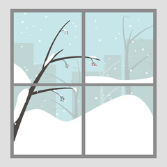 Large window with the snowy winter, a viburnum tree with snow on the branches and silhouettes of buildings in the background