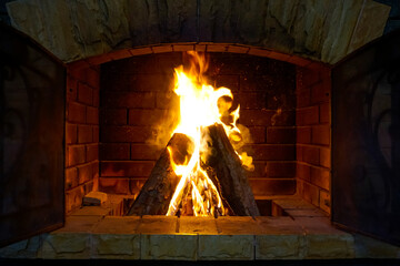Bright warm fire in a brick fireplace