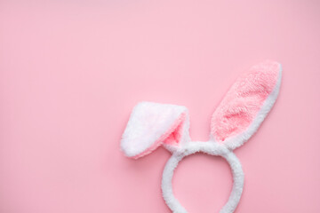 Fluffy pink ears of an easter bunny on a pink background. Flat lay, place for text. Easter concept.