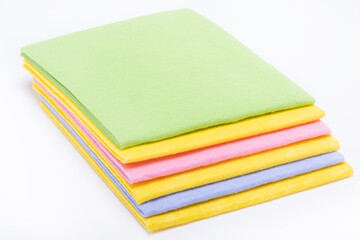 Multicolored cleaning napkins on white background